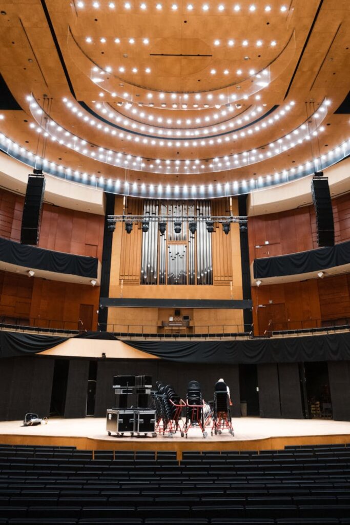 Interior view of a modern concert hall featuring a grand organ on stage.